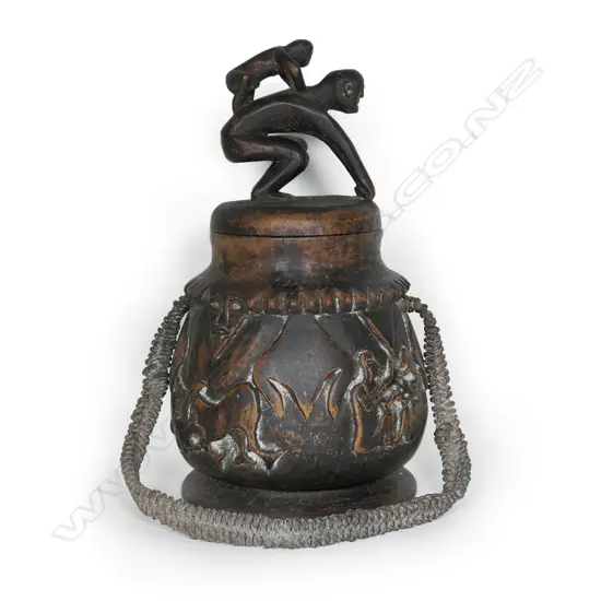 A large carved wood lime container with figural (man & boy) cover,
